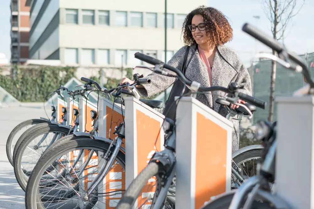 Image of woman taking bike instead of car to help environment