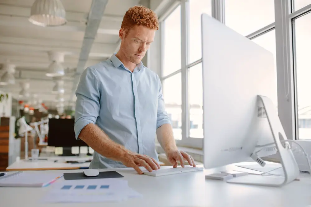 Image of a standing desk in an office, a solution to a sedentary lifestyle