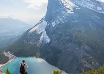 aerial photography of man standing on hill