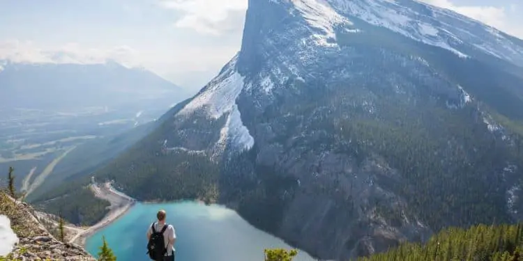aerial photography of man standing on hill
