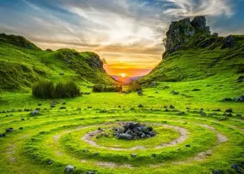 green grass field during sunset