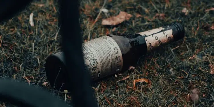 a bottle of wine on a persons leg