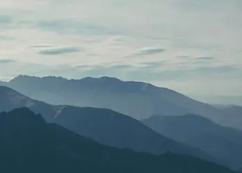 silhouette of mountains covered with fog